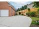 Spacious driveway leading to garage with backyard area featuring wooden fence for added privacy at 11385 Donnington Dr, Duluth, GA 30097