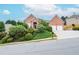 Charming red brick home with a manicured front yard and a two-car garage on a picturesque street at 11385 Donnington Dr, Duluth, GA 30097