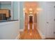 Hallway with hardwood floors leading to the front door and has an ornate chandelier at 11385 Donnington Dr, Duluth, GA 30097