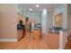 Spacious kitchen featuring stainless steel appliances, hardwood floors, and light wood cabinetry at 11385 Donnington Dr, Duluth, GA 30097
