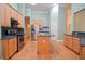 Open kitchen features stainless steel appliances, center island, hardwood floors, and light wood cabinetry at 11385 Donnington Dr, Duluth, GA 30097