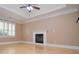 Cozy living room with hardwood floors, fireplace and tray ceilings at 11385 Donnington Dr, Duluth, GA 30097