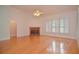 Bright living room with hardwood floors, a brick fireplace, and large, sunny windows at 11385 Donnington Dr, Duluth, GA 30097