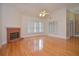 Bright and airy living room with hardwood floors, fireplace, and lots of natural light at 11385 Donnington Dr, Duluth, GA 30097