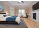 Staged main bedroom offers fireplace, tray ceilings and bright natural light at 11385 Donnington Dr, Duluth, GA 30097