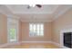 Main bedroom offers tray ceilings, access to outdoor space and fireplace at 11385 Donnington Dr, Duluth, GA 30097
