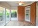 Well-lit sunroom with a brick accent wall, wooden flooring, and ample natural light at 11385 Donnington Dr, Duluth, GA 30097