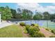Community tennis courts with lush landscaping and ample seating for spectators at 11385 Donnington Dr, Duluth, GA 30097