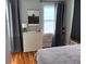 Bright bedroom with gray curtains, light-colored dresser, and a view to the outside at 23 Poplar St, Porterdale, GA 30014