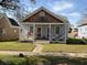 Charming single-story home with a welcoming front porch and well-maintained lawn at 23 Poplar St, Porterdale, GA 30014