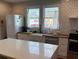 Bright kitchen with large island, modern appliances and farmhouse sink at 23 Poplar St, Porterdale, GA 30014
