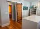 Kitchen shows a large island with white countertop and natural wood floors at 23 Poplar St, Porterdale, GA 30014