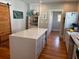 Bright kitchen features a large island with white countertop and natural wood floors at 23 Poplar St, Porterdale, GA 30014
