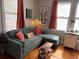 Comfortable living room with gray sofa, accent pillows, and lots of sunlight at 23 Poplar St, Porterdale, GA 30014