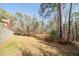 Lush backyard with mature trees, retaining wall, and green space at 3968 Belle Glade Ct, Snellville, GA 30039