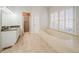 Elegant bathroom featuring a soaking tub, granite countertops, and tile floors at 3968 Belle Glade Ct, Snellville, GA 30039