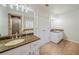 Well-lit bathroom with double vanity, granite counters, and tile flooring at 3968 Belle Glade Ct, Snellville, GA 30039