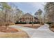 Stately brick home with a circular driveway and mature trees on a large lot at 3968 Belle Glade Ct, Snellville, GA 30039