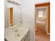 Bathroom vanity with large mirror, offering a glimpse into an adjacent bedroom at 4161 Windermere Dr, Lithonia, GA 30038