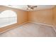 Spacious bedroom with a large arched window and ceiling fan at 4161 Windermere Dr, Lithonia, GA 30038