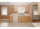 Kitchen with beige cabinets, white appliances, and tile flooring at 4161 Windermere Dr, Lithonia, GA 30038