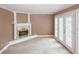 Inviting living room highlighting a fireplace and french doors, creating a cozy and bright space at 4161 Windermere Dr, Lithonia, GA 30038