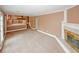 Spacious living room featuring a cozy fireplace, carpet flooring, and staircase in neutral colors at 4161 Windermere Dr, Lithonia, GA 30038