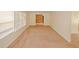 Open living room featuring bright windows, carpet flooring, and neutral walls at 4161 Windermere Dr, Lithonia, GA 30038
