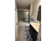 Well-lit bathroom featuring a tub with glass doors, modern sink, and neutral color scheme at 323 Concord St, Alpharetta, GA 30009