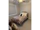 Cozy bedroom with a twin bed, floral comforter, window with blinds and neutral carpet at 323 Concord St, Alpharetta, GA 30009