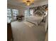 Bright bedroom featuring large windows, floral wallpaper, comfortable seating, and carpeted floors at 323 Concord St, Alpharetta, GA 30009