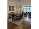 Open-concept dining area with wood table, chandelier, and hardwood floors at 323 Concord St, Alpharetta, GA 30009