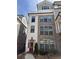 Three story townhome with brick and Hardie board exterior, red door and black trim at 323 Concord St, Alpharetta, GA 30009