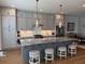 Gourmet kitchen features a large center island with seating, gray cabinets and stainless steel appliances at 323 Concord St, Alpharetta, GA 30009