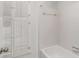 Clean, tiled bathroom with white fixtures and a bright window featuring white shutters at 402 Bainbridge Dr, Atlanta, GA 30327