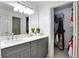 Bathroom featuring gray vanity with sleek hardware and nearby walk-in closet at 402 Bainbridge Dr, Atlanta, GA 30327