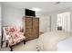Comfortable bedroom featuring a decorative chair and an open entry to an adjacent room at 402 Bainbridge Dr, Atlanta, GA 30327