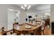 Spacious dining room with wood table, chandelier, and open view to other rooms at 402 Bainbridge Dr, Atlanta, GA 30327