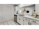 Modern kitchen featuring stainless steel dishwasher and sink, white counters, and white cabinets at 402 Bainbridge Dr, Atlanta, GA 30327