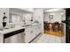 Bright kitchen with white cabinets and counters with a view into the dining and living rooms at 402 Bainbridge Dr, Atlanta, GA 30327