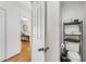 Cozy powder room with storage shelves above the toilet and hardwood floors at 402 Bainbridge Dr, Atlanta, GA 30327