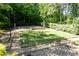 A well-maintained recreation area with seating and lush green grass surrounded by natural scenery at 402 Bainbridge Dr, Atlanta, GA 30327