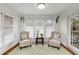Bright sun room with large windows, comfortable seating, and a peaceful atmosphere for relaxing and enjoying the view at 402 Bainbridge Dr, Atlanta, GA 30327
