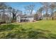 Large, grassy backyard with a deck and patio area, perfect for outdoor entertaining at 596 Frank Kirk Nw Rd, Kennesaw, GA 30152