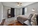 Cozy bedroom with hardwood floors, gray walls, soft rug, and natural lighting at 596 Frank Kirk Nw Rd, Kennesaw, GA 30152