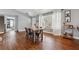 Bright dining room with hardwood floors, a stylish bar cart, and natural light streaming through the windows at 596 Frank Kirk Nw Rd, Kennesaw, GA 30152