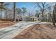 Landscaped yard, long drive, and mature trees surround this charming home's exterior at 596 Frank Kirk Nw Rd, Kennesaw, GA 30152