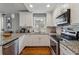 Well-lit kitchen with granite countertops, stainless steel appliances, and white cabinets at 596 Frank Kirk Nw Rd, Kennesaw, GA 30152