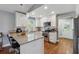 Bright kitchen with white cabinets, granite countertops, stainless steel appliances, and a breakfast bar at 596 Frank Kirk Nw Rd, Kennesaw, GA 30152