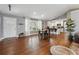 Open-concept living area features hardwood floors, white trim, and ample natural light from large windows at 596 Frank Kirk Nw Rd, Kennesaw, GA 30152